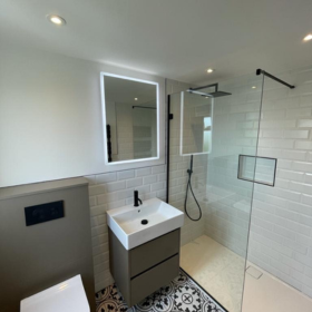 a bathroom with a glass shower door